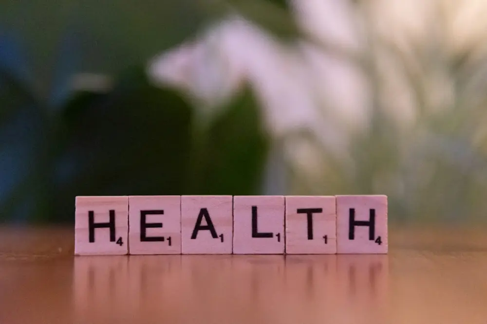 A wooden block spelling the word health on a table, illustrating mens health awareness